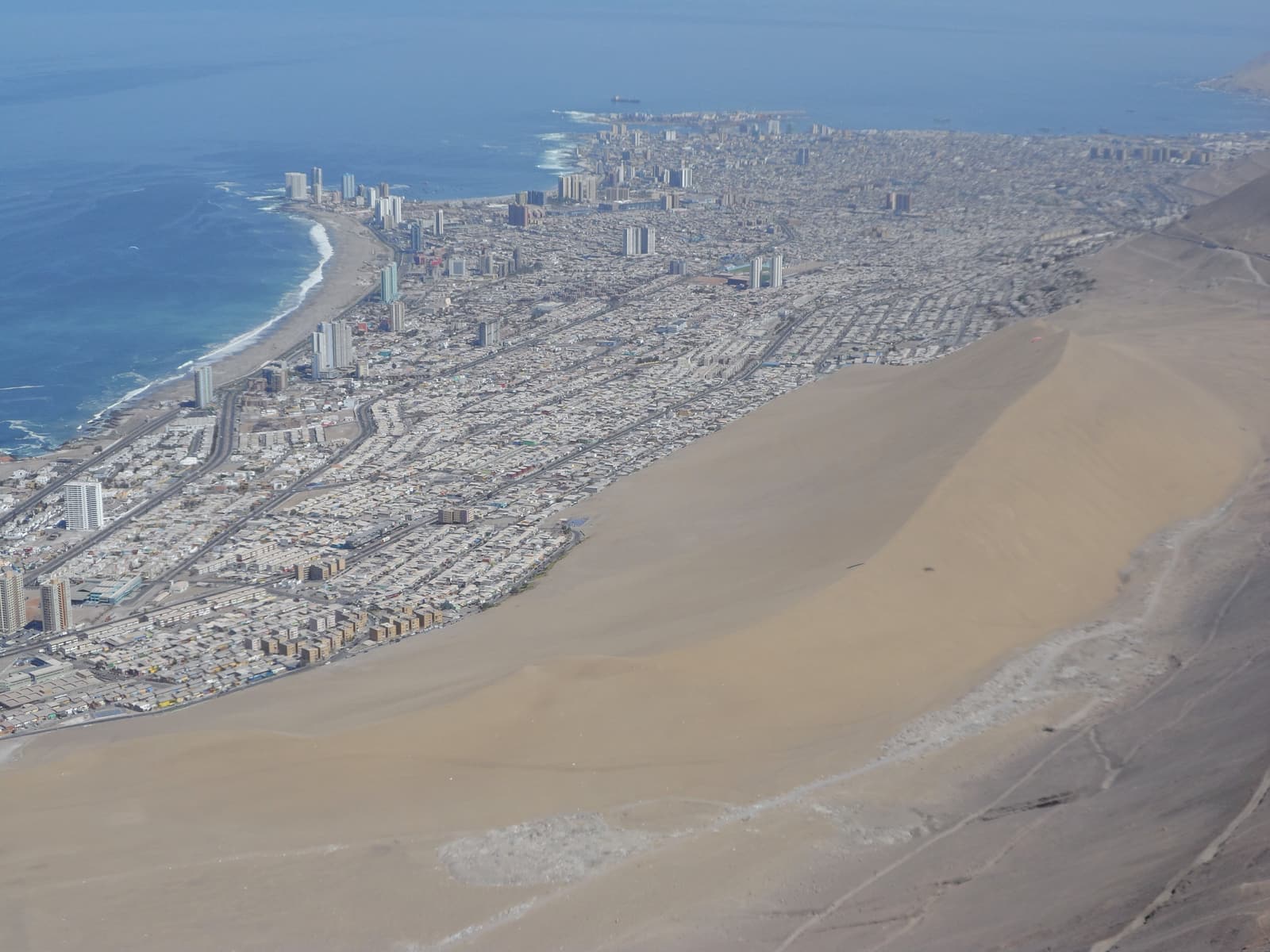 Iquique and the Cerro Dragón dune seen from a paraglider